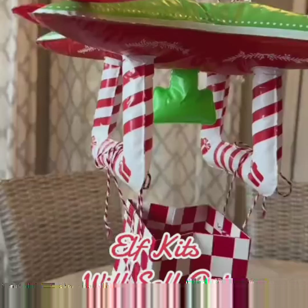 Showing the Red and green inflatable elf drone toy prop from the 24 day elf kit.